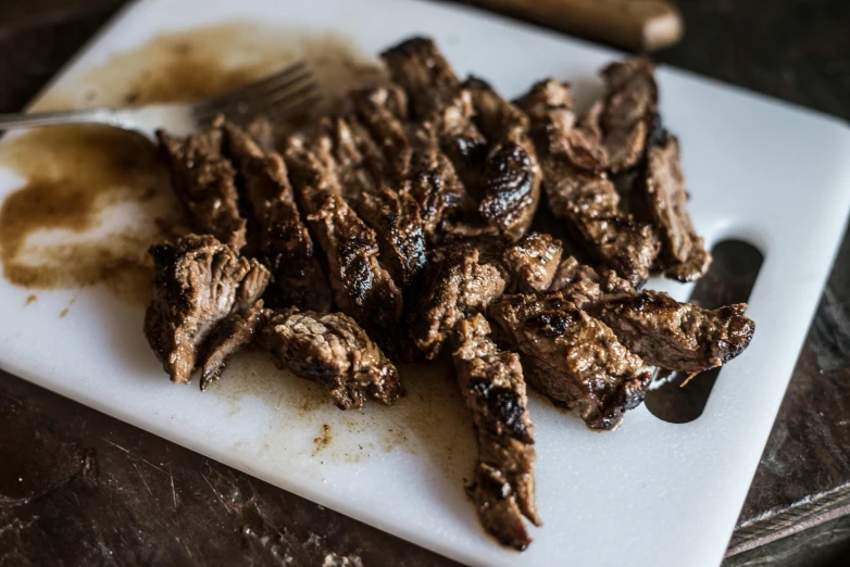 a cutting board that has some meat on it, unsplash, lomo saltado, fan favorite, profile image, chocolate