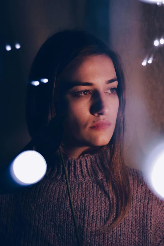 a close up of a person holding a cell phone, a picture, inspired by Elsa Bleda, cinematic headshot portrait, symmetric lights, floating lights, model posing