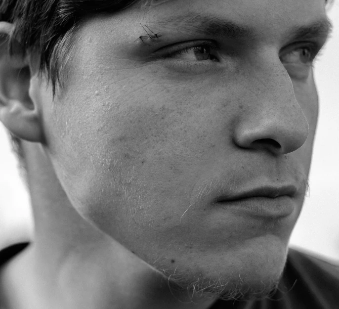 a black and white photo of a young man, by Lasar Segall, pexels, hyperrealism, square masculine jaw, tom jobim, portrait of ultra realistic, nose