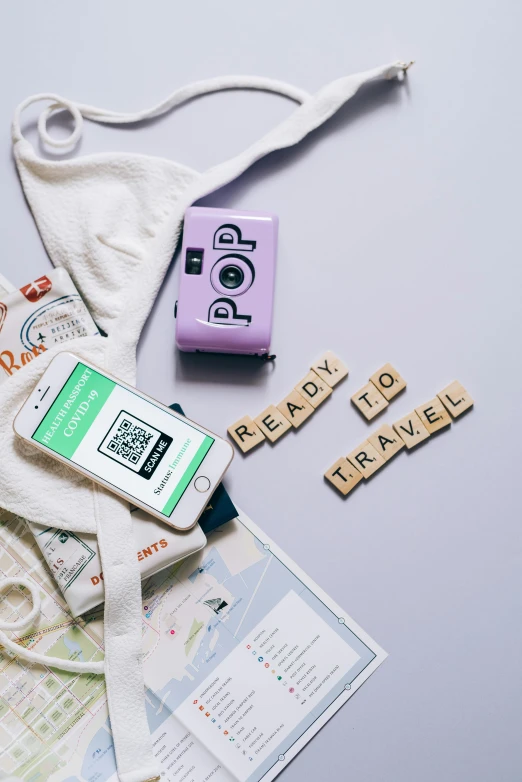 the contents of a travel bag laid out on a table, a polaroid photo, trending on pexels, happening, smartphone displays qr code, 2 0 2 5 popstar comeback single, pregnancy, neon letters tripmachine