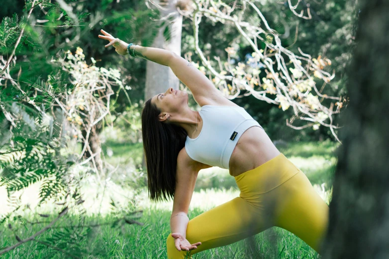 a woman in yellow pants doing a yoga pose, a picture, unsplash, sydney park, vines, avatar image, anna nikonova aka newmilky
