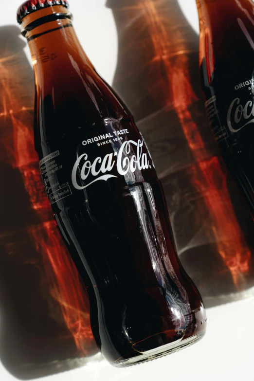 three bottles of coca cola sitting next to each other, pexels, hyperrealism, close up to the screen, brown, high - contrast, thumbnail