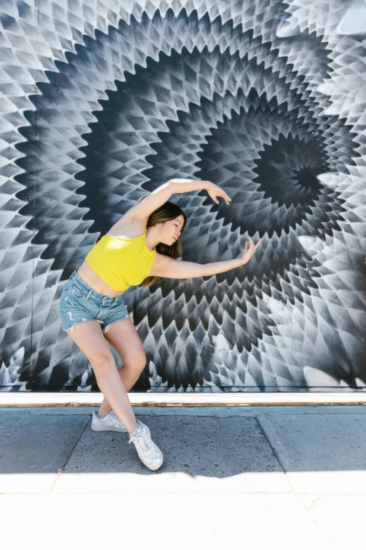 a woman that is standing in front of a wall, inspired by Gabriel Dawe, pexels contest winner, kinetic art, playful pose of a dancer, sydney sweeney, sheryl sandberg at soulcycle, museum quality photo