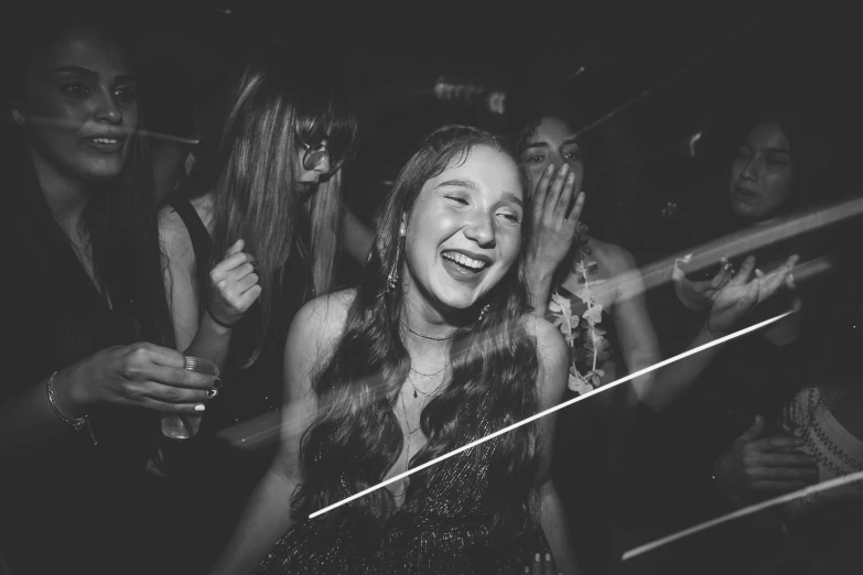 a group of women standing next to each other at a party, a black and white photo, by Emma Andijewska, pexels, happening, smiling girl, 1024x1024, teenager girl, she is dancing