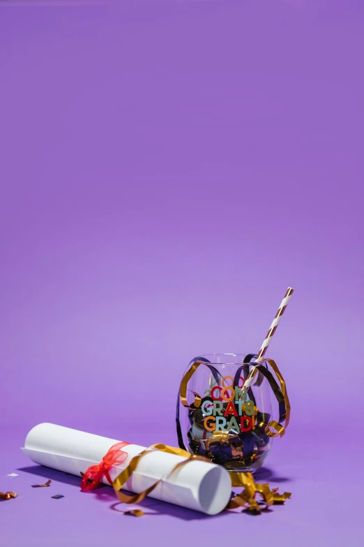 a roll of paper next to a glass filled with confetti, by Peter Alexander Hay, trending on pexels, pop art, purple tubes, smoking a joint, 12, made of lollypops