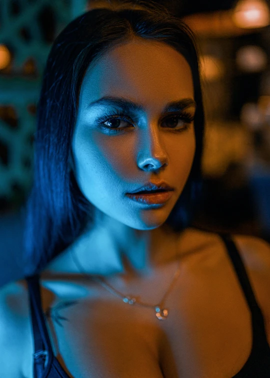 a woman in a black bra top posing for a picture, a portrait, inspired by Elsa Bleda, trending on pexels, holography, blue hour, jewelry lighting, with haunted eyes and dark hair, nose ring