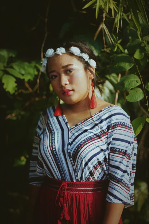 a woman with a flower in her hair, an album cover, inspired by Sasha Putrya, unsplash, hurufiyya, wearing authentic attire, samoan features, teenager, medium format. soft light