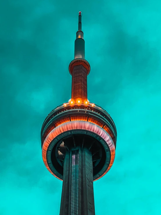 a tall tower with a blue sky in the background, by Julia Pishtar, pexels contest winner, cn tower, orange and cyan lighting, vibrant but dreary, circular towers