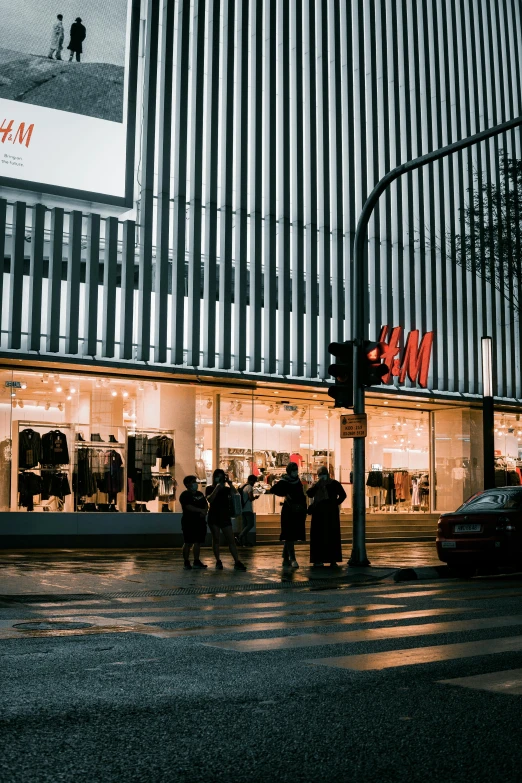 a group of people crossing a street in front of a store, a picture, unsplash, realism, calm evening, berlin fashion, p. j. n, shopwindows