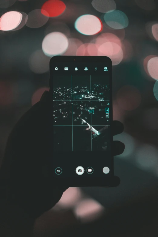 a person taking a picture of a city at night, a picture, trending on pexels, a portrait of an android, dark screen, holding it out to the camera, slightly pixelated