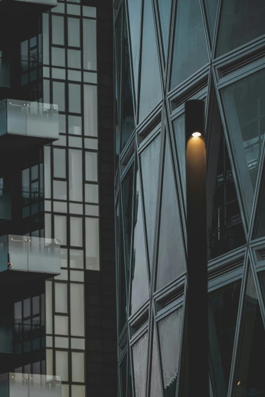 a couple of tall buildings next to each other, inspired by Zaha Hadid, unsplash contest winner, modernism, streetlight, steel window mullions, ignant, mysterious exterior