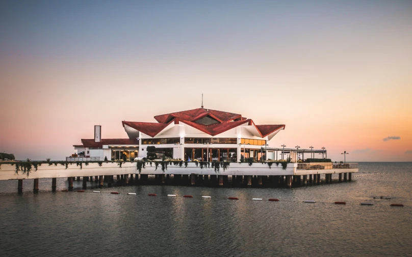 a large building sitting on top of a body of water, pexels contest winner, d. i. y. venue, seaview, pavilion, ayne haag