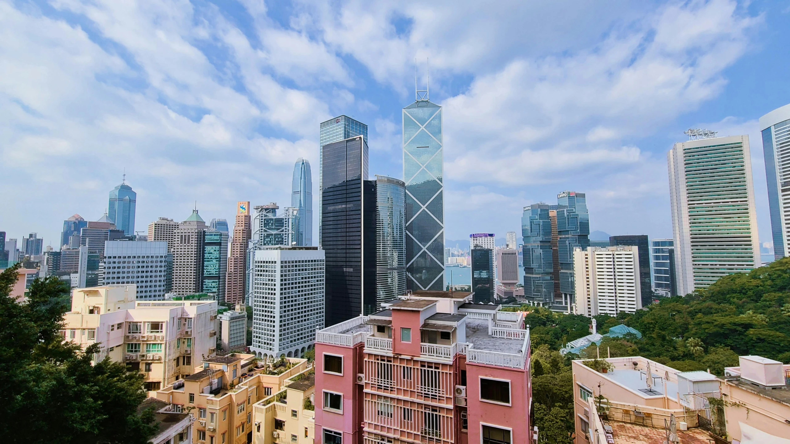 a view of a city from a high rise building, by Patrick Ching, pexels contest winner, hyperrealism, pink marble building, chinese building, 2000s photo, skyscrapers with greenery