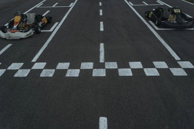 a couple of go karts sitting on top of an airport tarmac, pexels contest winner, les automatistes, square, crossing the line, daniel ricciardo, 15081959 21121991 01012000 4k
