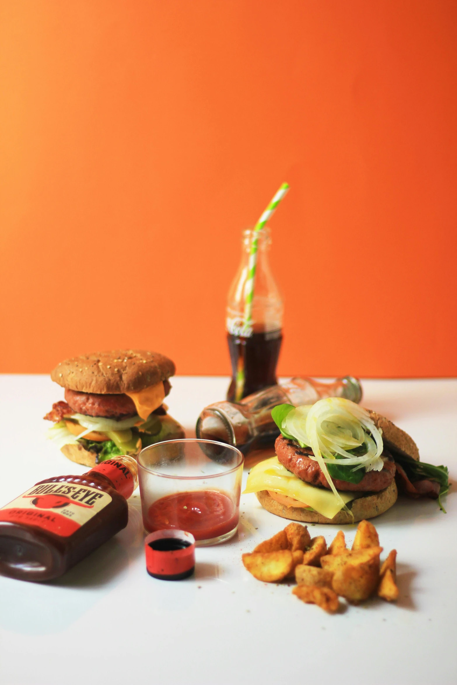 a couple of hamburgers sitting on top of a table, a still life, inspired by Gillis Rombouts, ash ketchup, profile image, ingredients on the table, drinks