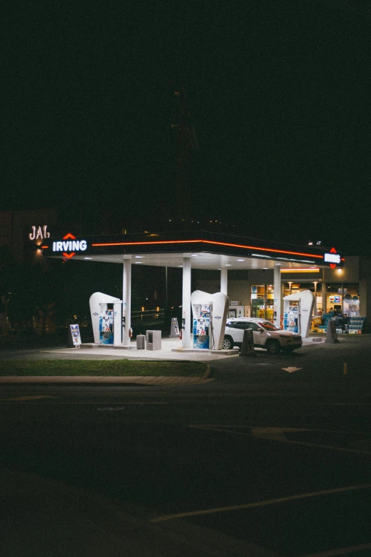 a gas station is lit up at night, a polaroid photo, unsplash contest winner, hyperrealism, 2 5 6 x 2 5 6 pixels, jaw dropping, hydrogen fuel cell vehicle, stephen shore & john j. park