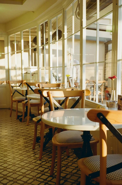 a restaurant filled with lots of tables and chairs, by Pamela Ascherson, unsplash, art nouveau, overexposed sunlight, demur, vanilla, tea