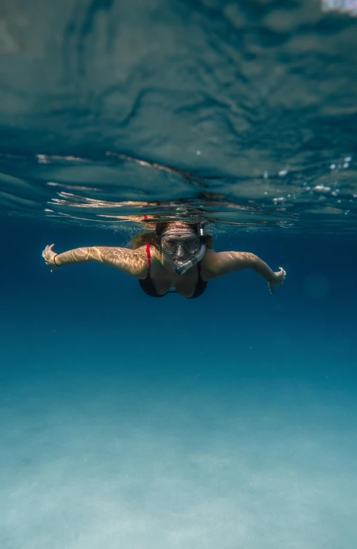 a woman swimming in the ocean with a mask on, by Peter Churcher, pexels contest winner, upsidedown, shot on sony a 7 iii, big sky, no words 4 k
