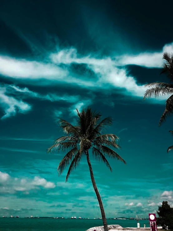 a car parked on the side of a road next to a beach, an album cover, pexels contest winner, romanticism, coconut palms, dramatic clouds cyan atmosphere, profile image, view from below