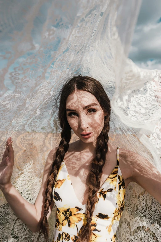 a woman in a floral dress with a veil over her head, pexels contest winner, woman with braided brown hair, sea foam, dressed in a frilly ((lace)), portrait sophie mudd