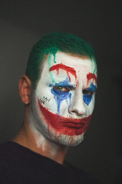 a man with his face painted like the joker, a colorized photo, by artist, trending on reddit, renaissance, on a gray background, square, lgbtq, фото девушка курит