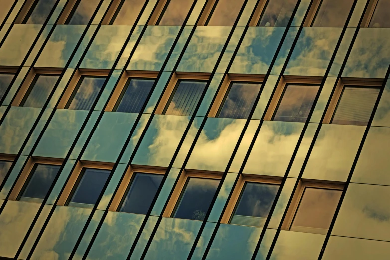 the sky is reflected in the windows of a building, inspired by Richard Wilson, pexels contest winner, golden hues, thumbnail, square lines, cloud palace