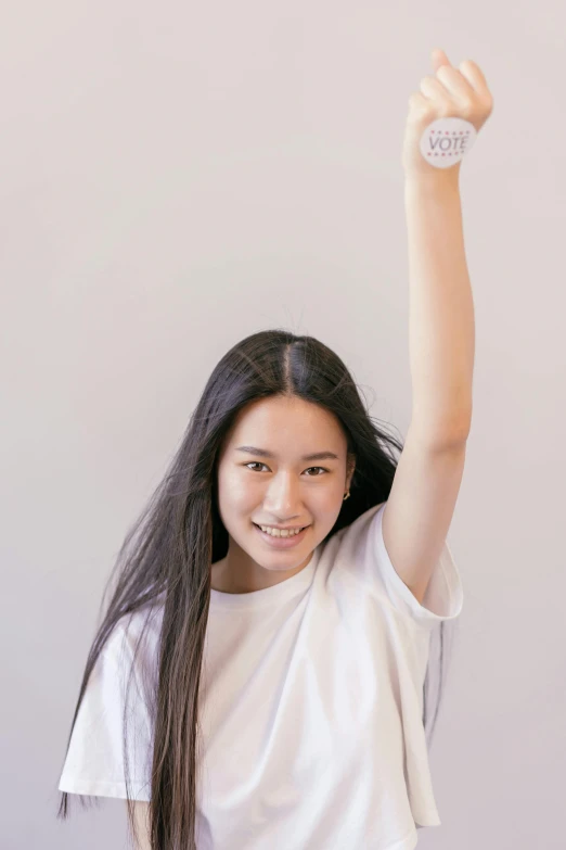 a woman holding a donut up in the air, dressed in a white t shirt, gongbi, raising an arm, background image