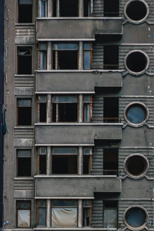 a tall building with lots of windows and balconies, inspired by Matthias Jung, unsplash contest winner, brutalism, portholes, broken down grey wall, orbit soviet city, photo 1998