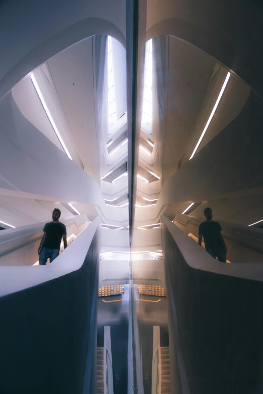 a couple of people that are inside of a building, inspired by Zaha Hadid, light and space, spaceship hallway, twins, reflecting, futuristic valley