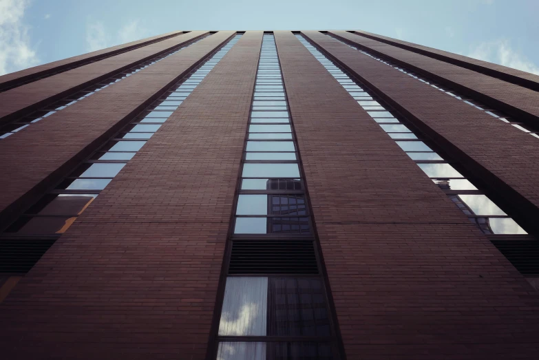 a tall brick building with lots of windows, unsplash, brutalism, 70s photo, worm's eye view, square lines, cinematic shot ar 9:16 -n 6 -g