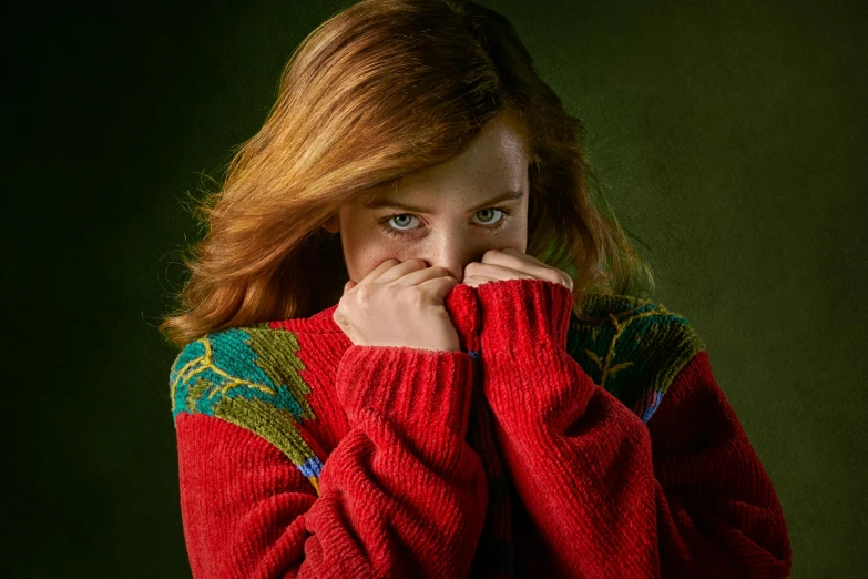 a woman in a red sweater covers her face with her hands, an album cover, by irakli nadar, shutterstock contest winner, hyperrealism, sadie sink, harry potter portrait, sweater, red and green hour