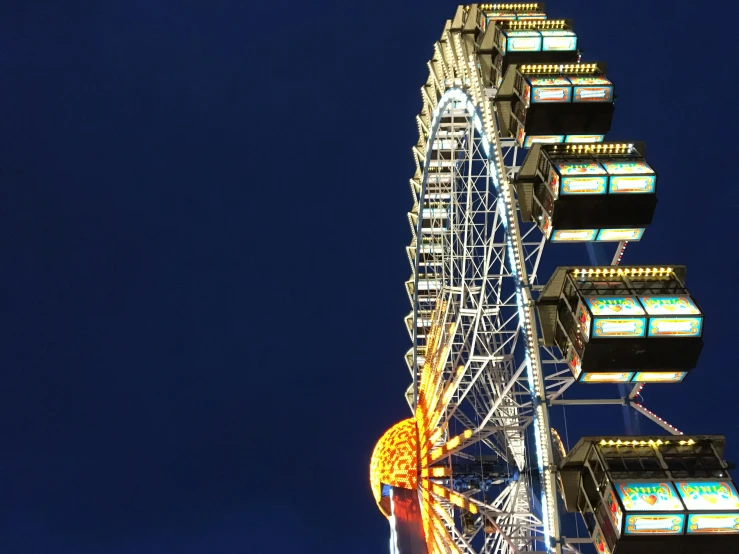 a ferris wheel lit up at night against a blue sky, by Matthias Stom, pexels contest winner, avatar image, towering high up over your view, profile image, extra high resolution