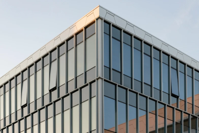 a very tall building with a lot of windows, inspired by David Chipperfield, unsplash, metal cladding wall, street corner, close-up from above, cornell