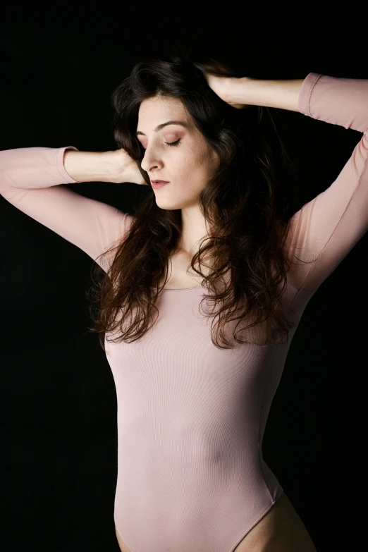 a woman in a pink leoper leoper leoper leoper leoper leoper leoper leoper leoper leoper leoper leo, an album cover, inspired by Elizabeth Polunin, pexels contest winner, arabesque, tight shirt, peaceful and graceful, rachel weisz portrait, no - text no - logo