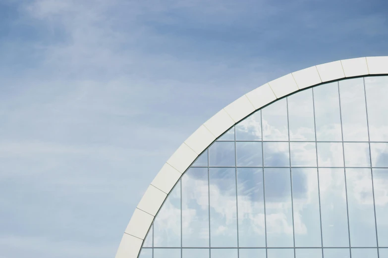 a plane is flying in front of a building, inspired by Richard Wilson, unsplash, modernism, white sweeping arches, clear glass wall, shot from roofline, sky blue