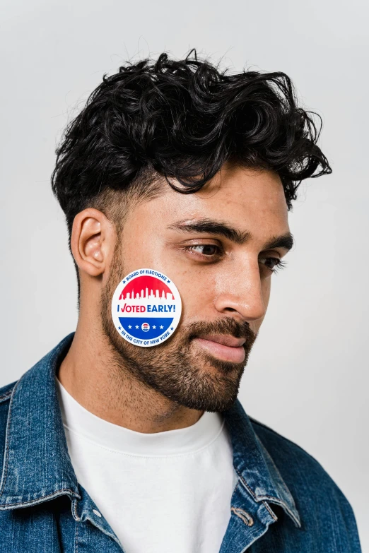 a man with a sticker on his face, short scruffy beard, non binary model, rahul gandhi hairstyle, latino american