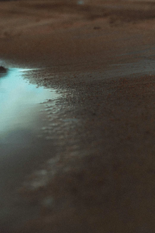 a body of water sitting on top of a sandy beach, an album cover, unsplash contest winner, australian tonalism, 8 k detail, puddles, photo 8 k, sandy colors