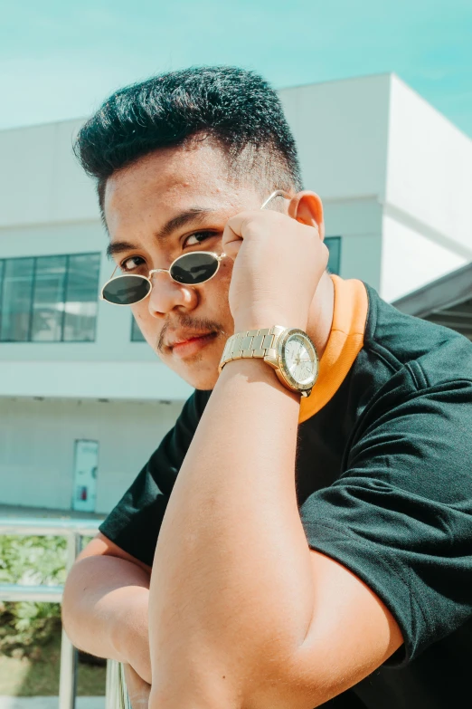 a man in a black shirt and sunglasses talking on a cell phone, an album cover, inspired by Ryan Yee, pexels contest winner, holding gold watch, looking away from camera, instagram picture, student