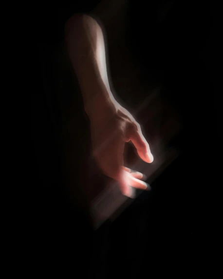 a close up of a person's hand on a keyboard, an album cover, inspired by casey baugh, unsplash, light and space, standing with a black background, emanating magic from her palms, dark. no text, translucent
