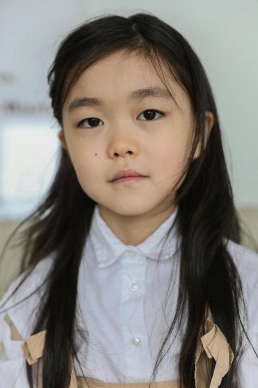 a little girl with long hair sitting on a couch, inspired by Yeong-Hao Han, pexels contest winner, shin hanga, closeup headshot portrait, ethnicity : japanese, girl standing, pale round face