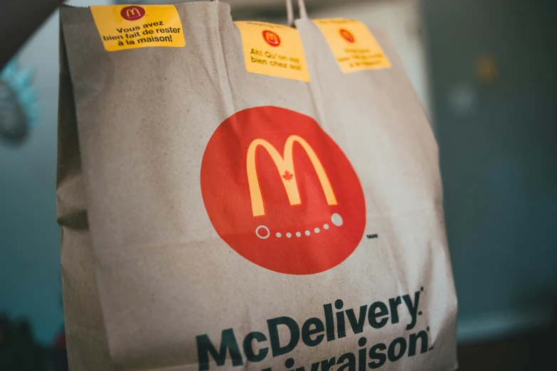 a paper bag with a mcdonald's logo on it, a cartoon, by Julia Pishtar, pexels, detail shot, 6 pack, delivering parsel box, thumbnail