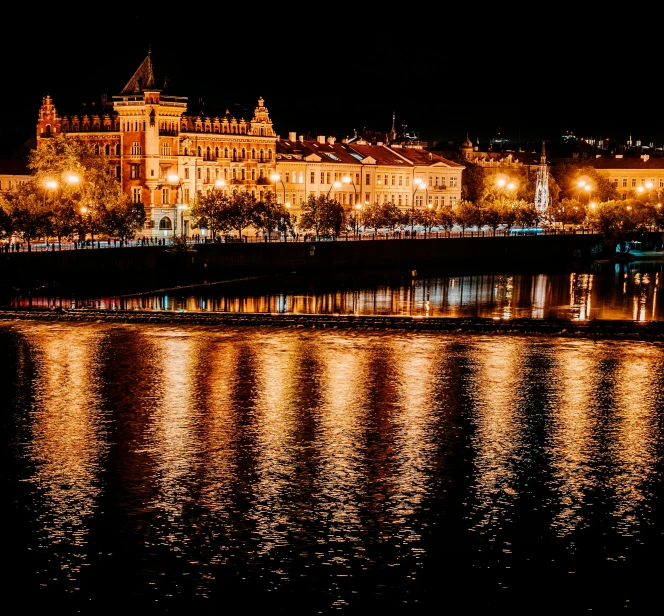 the lights on the buildings are reflecting in the water, by Julia Pishtar, pexels contest winner, art nouveau, khreschatyk, river of wine, festival. scenic view at night, gif
