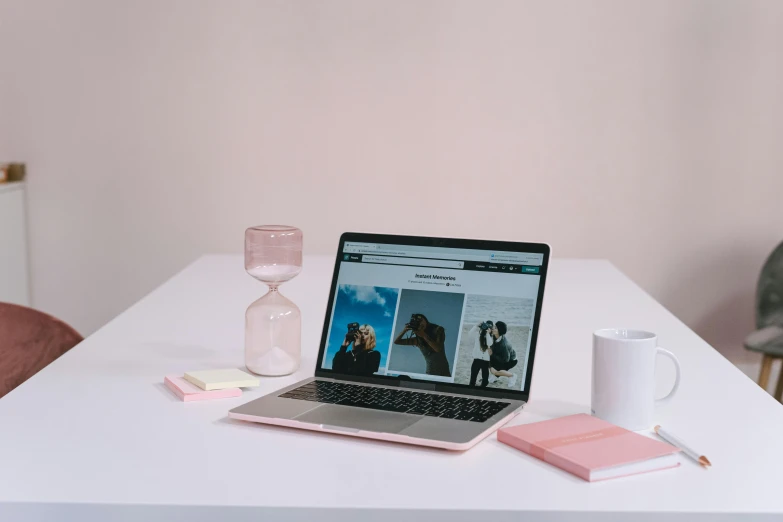 a laptop computer sitting on top of a white table, trending on pexels, pink, low quality photo, various items, single portrait