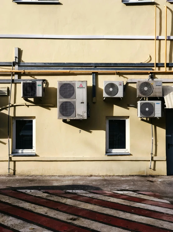 a group of air conditioning units on the side of a building, a photo, inspired by Elsa Bleda, unsplash, renaissance, thumbnail, silver and yellow color scheme, worried, фото девушка курит