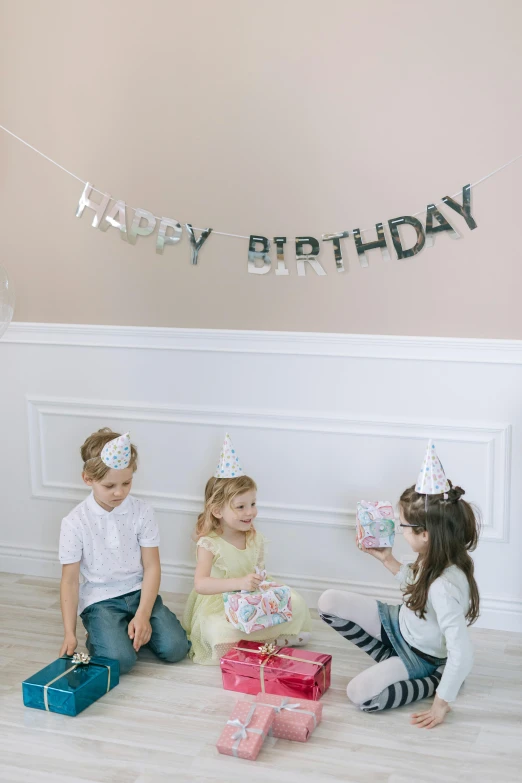 a group of children sitting on the floor with presents, tumblr, happening, white and silver, pals have a birthday party, 3 - piece, banner