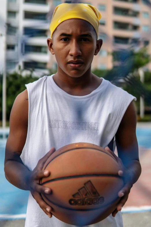 a young man holding a basketball on a basketball court, hyperrealism, colombian, 15081959 21121991 01012000 4k, ( ( brown skin ) ), ( ( theatrical ) )