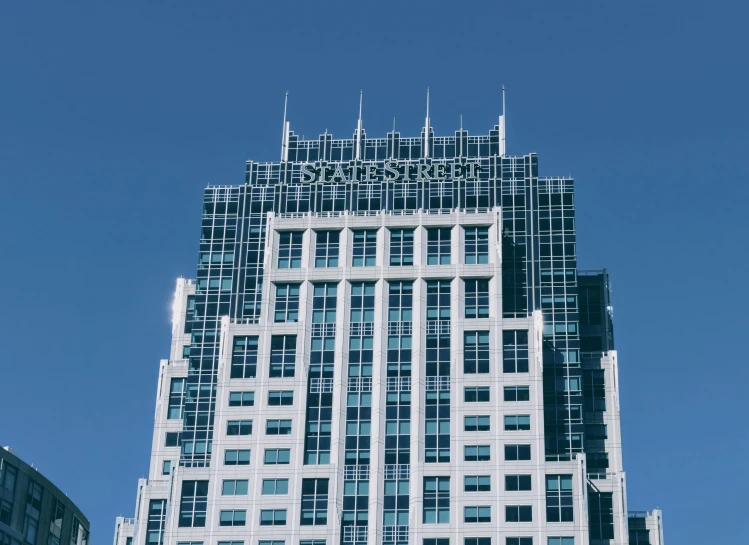 a tall building with a clock on top of it, stark, exterior photo, shades of blue and grey, staples