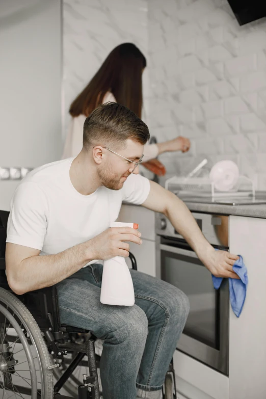 a man in a wheelchair cleaning a kitchen, profile image, male and female, dylan kowalski, on a white table