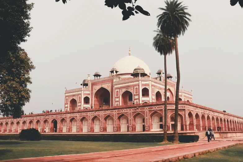 a red and white building surrounded by palm trees, pexels contest winner, renaissance, ancient india, trending on vsco, with great domes and arches, a park