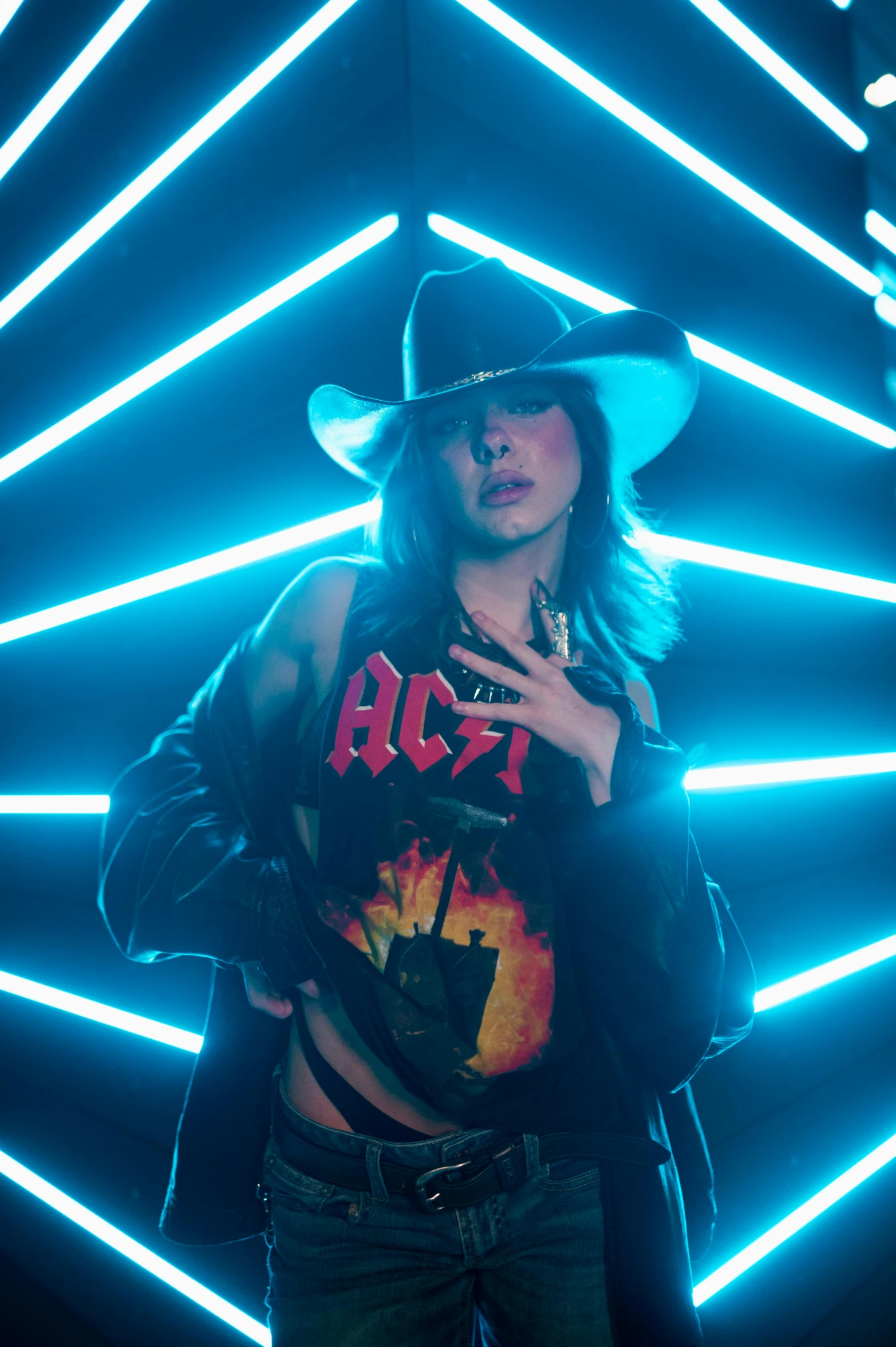 a man in a cowboy hat standing in front of neon lights, a portrait, inspired by Elsa Bleda, pexels, pop art, ana de armas as joan of arc, performing a music video, lady gaga, smoldering